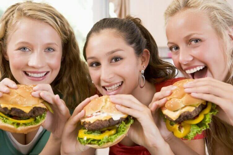 Teenage Girls Eating Burgers