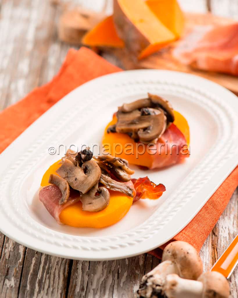 Medaglioni di zucca con speck nel piatto Medaglioni di zucca con speck