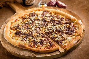 Pizza with onions, walnuts, and gorgonzola cheese, an excellent white pizza